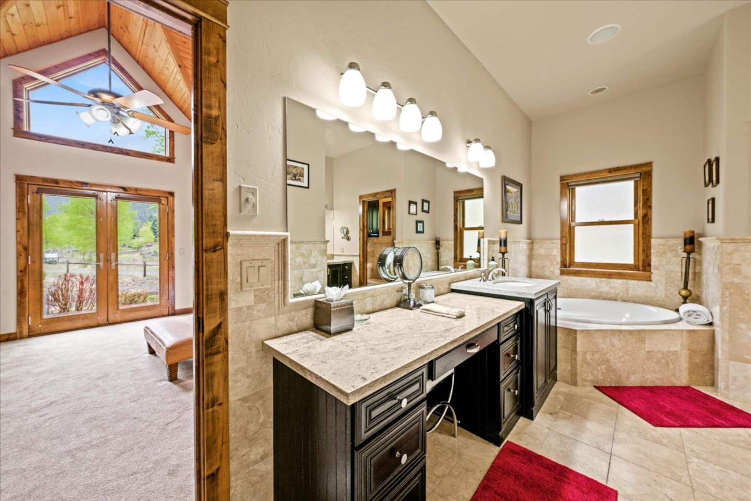 The long vanity and soaking tub in the primary bath