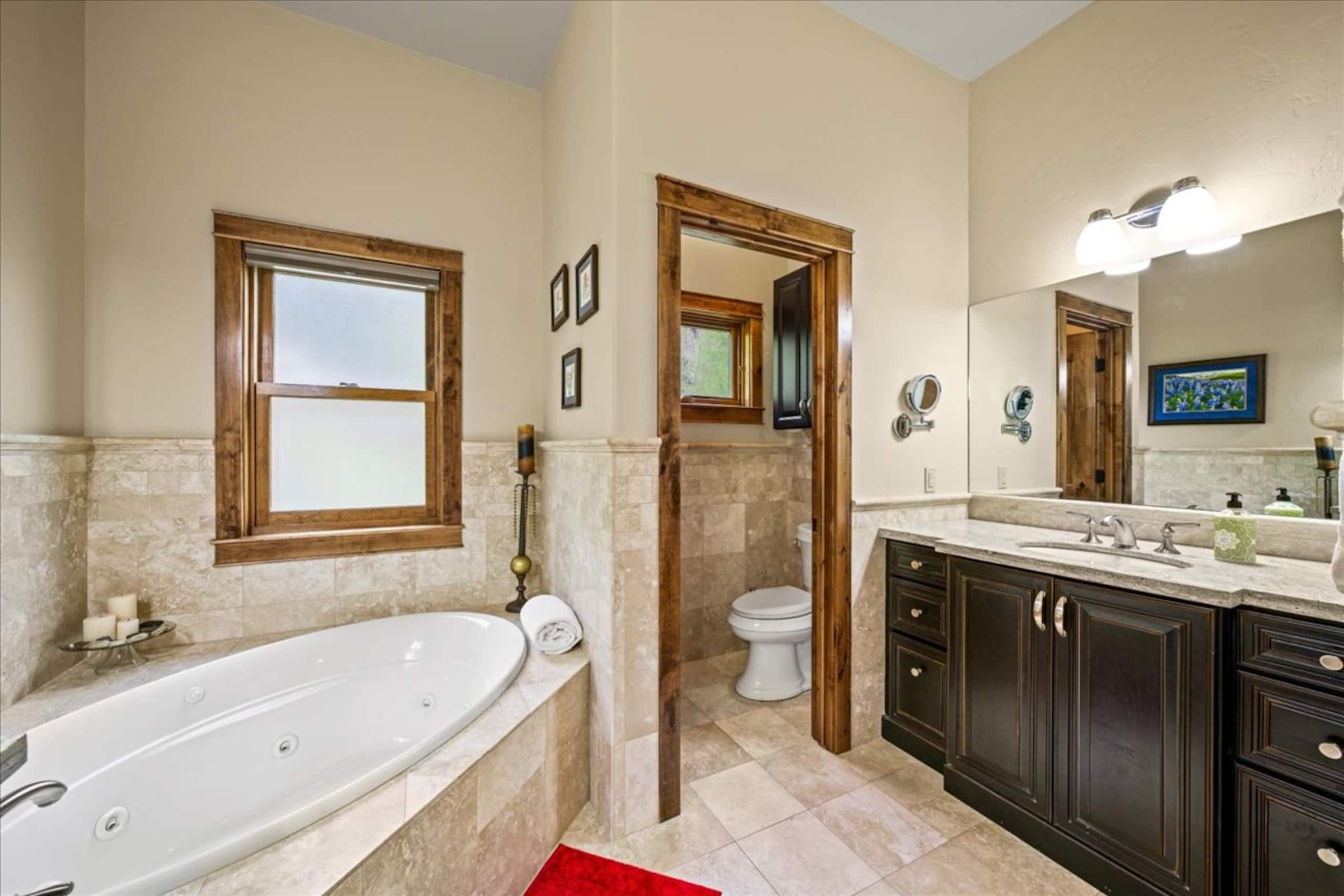 The corner soaking tub and dark vanity