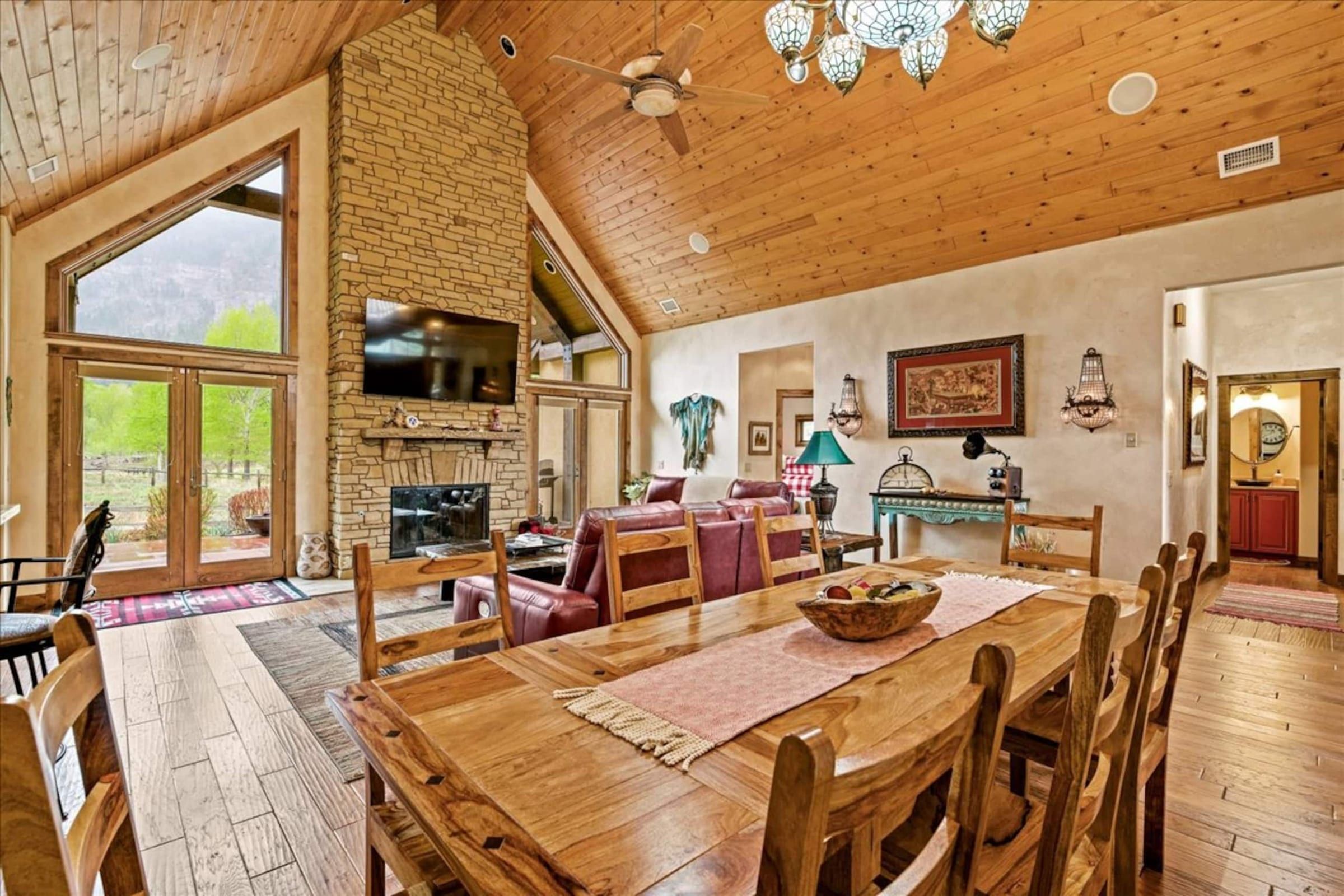 The dining table with the fireplace behind