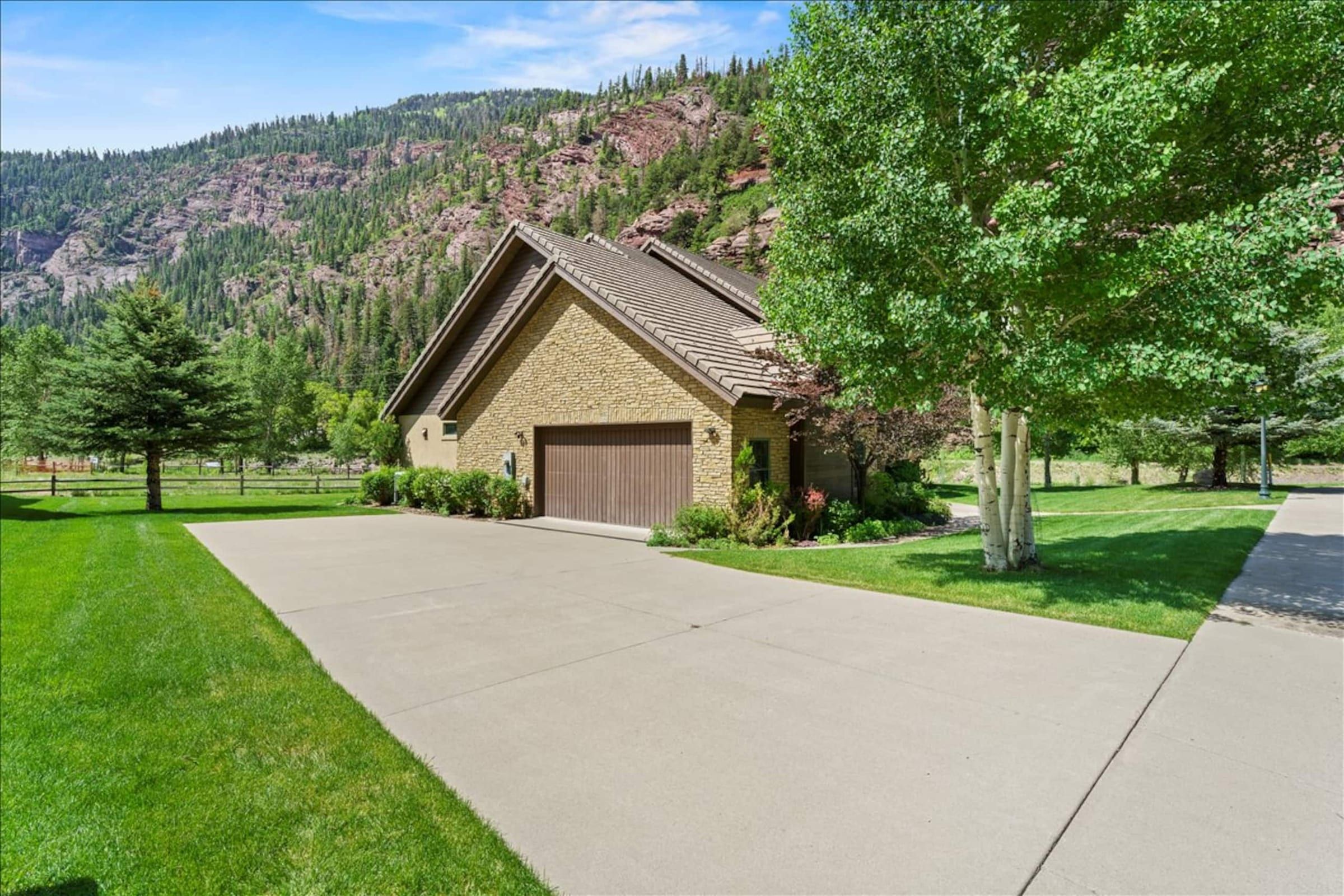 The driveway and garage, with mountains behind