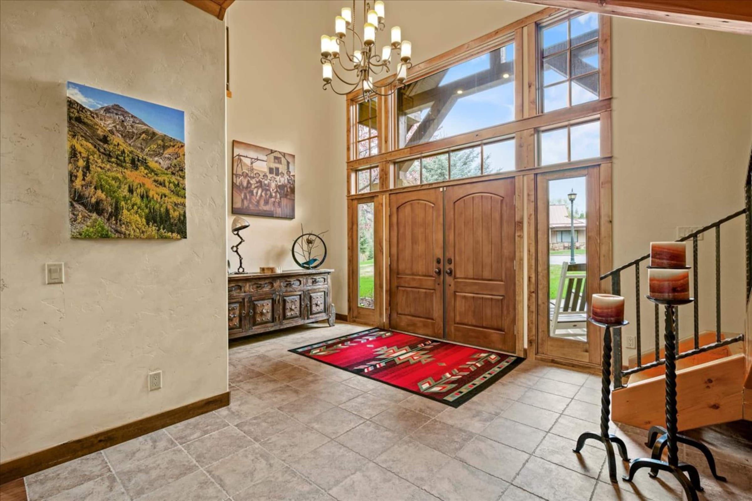 The front entry: a chandelier, tall windows and the stairs
