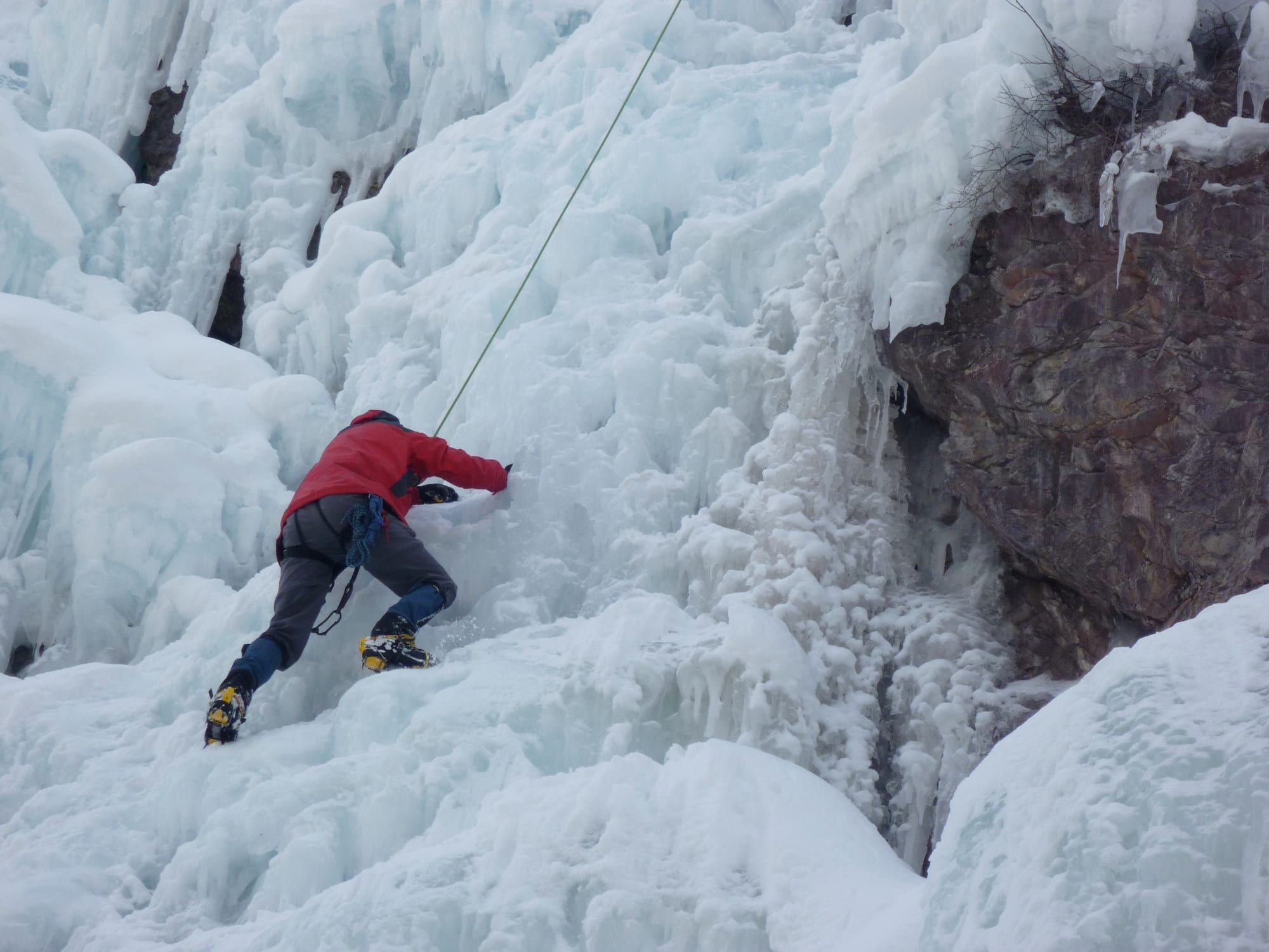A climber on a frozen waterfall at the Ouray Ice Park