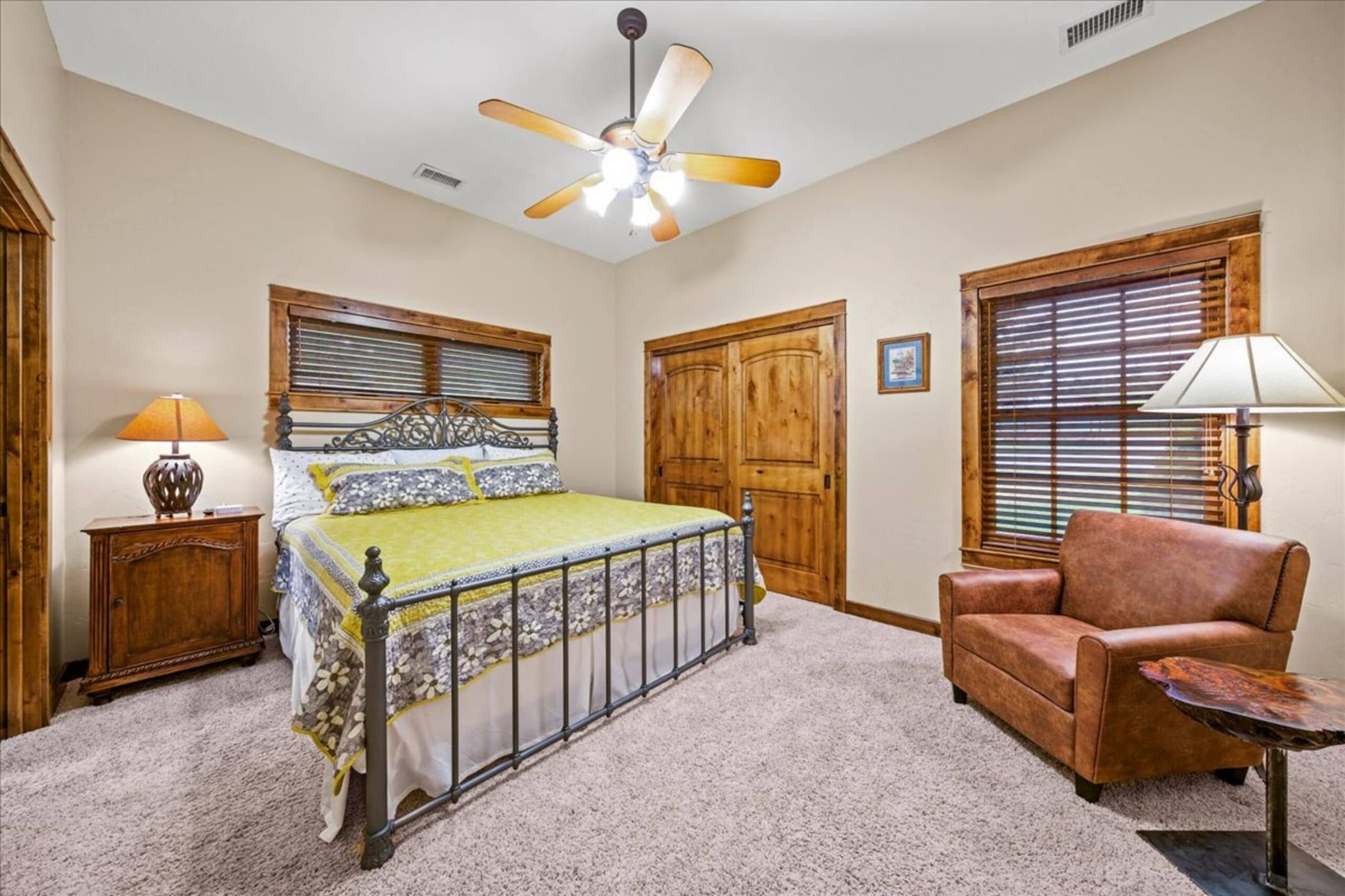 An iron king bed and a leather chair