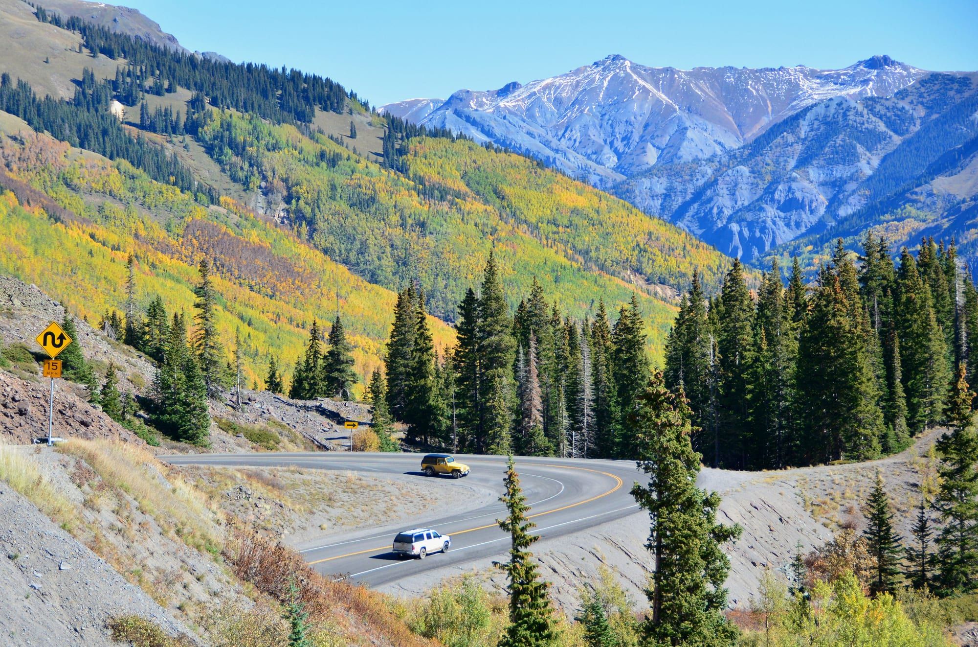 US 550 curving through fall aspens below the peaks